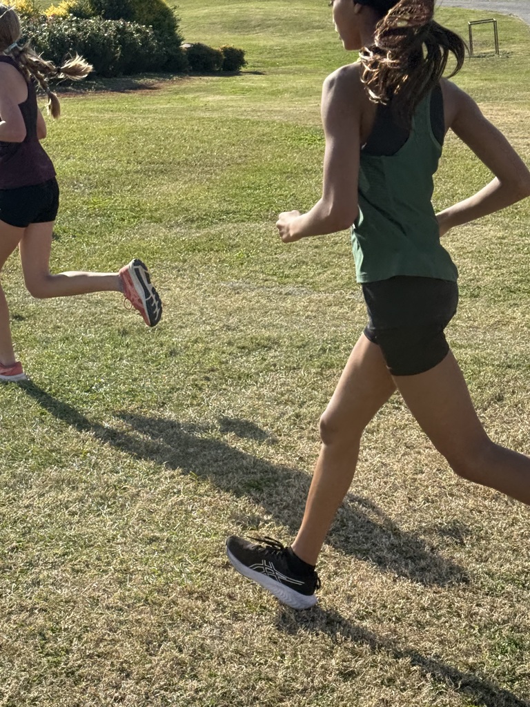 Student running in field for cross country
