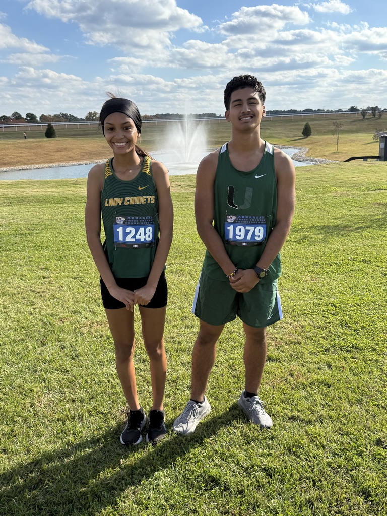 Two students standing in field