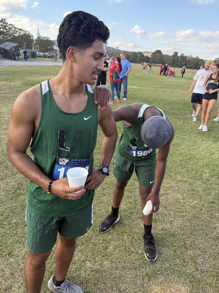 Students finishing race and one leaning on the other