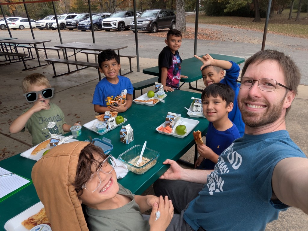 Two Languages Club at Cato Elementary posing for a picture while sharing a meal.