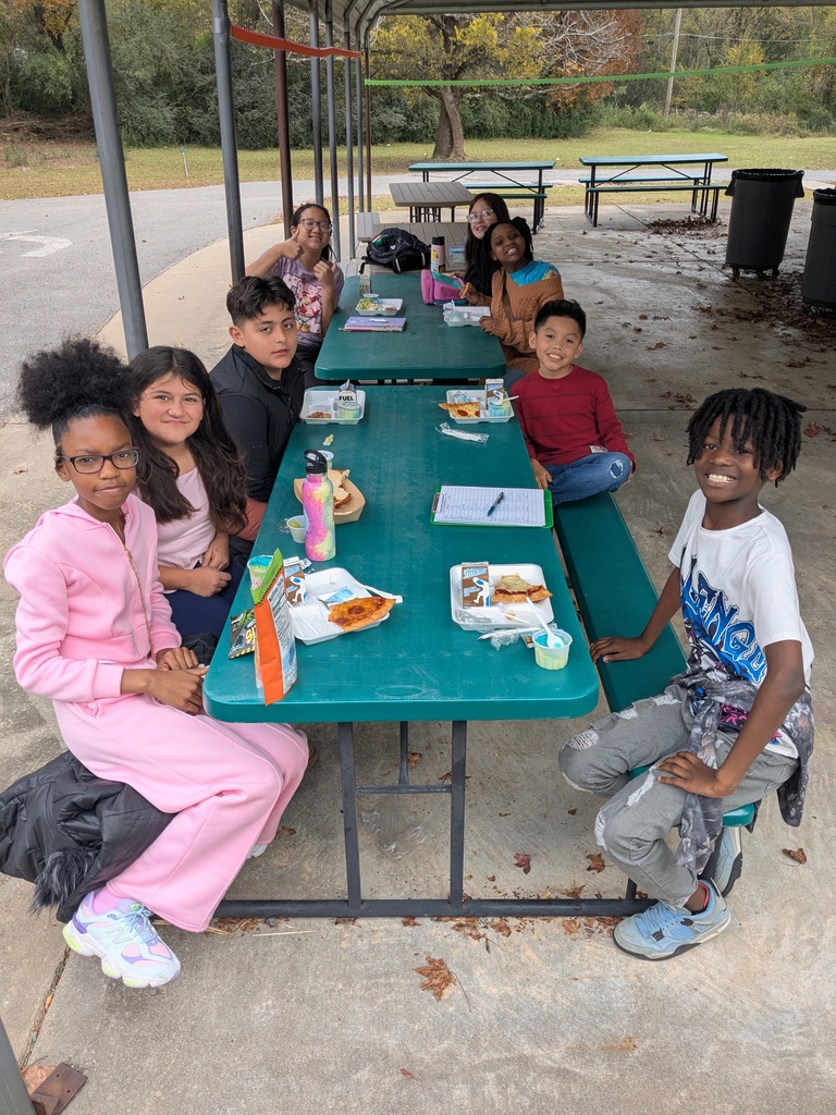 Two Languages Club at Cato Elementary posing for a picture while sharing a meal.