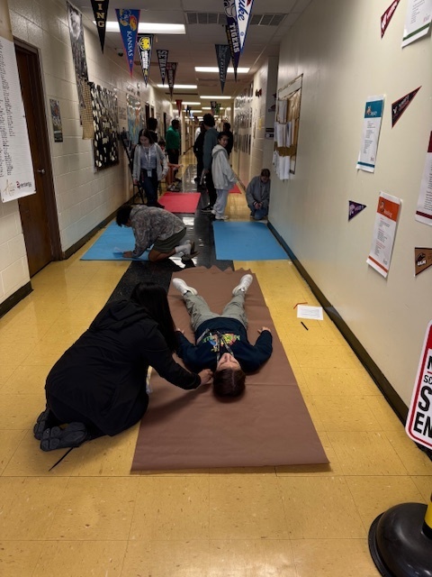 Teamwork in action! Students map out life-size body outlines as they dive into today’s hands on lesson.