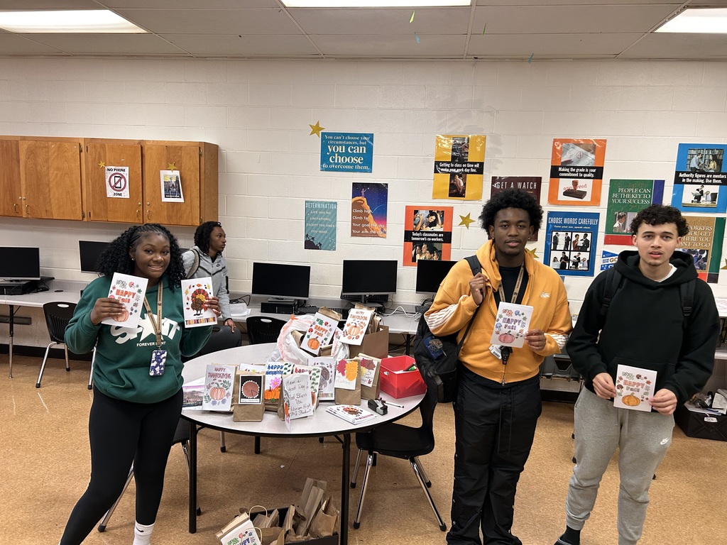Sharing gratitude, students show off the Thanksgiving cards they created for the Compassion Center.