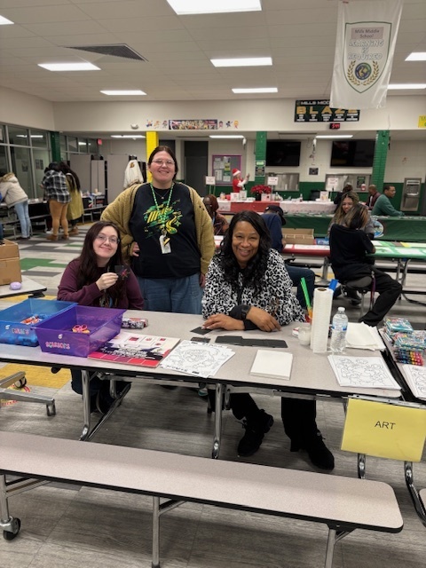 teachers smiling at art booth at Book Fair Family Night