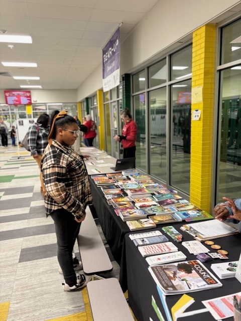 scholar looking at books and magazines at Book Fair Family Night