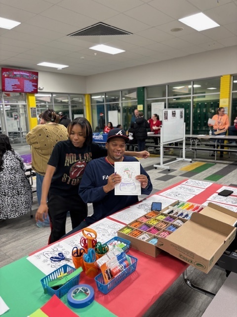 student at art vendor booth at Book Fair Family Night