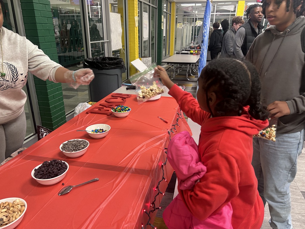 Student at FACA table Book Fair Family Night