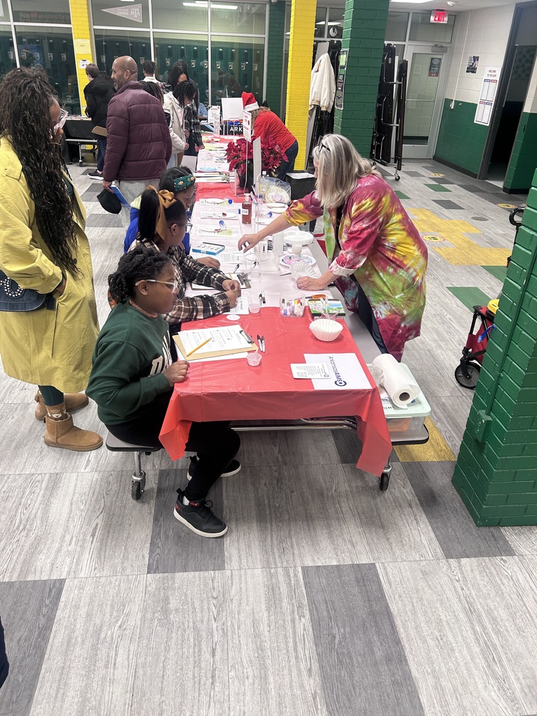 students at the ARAIMS vendor tables at Book Fair Family Night