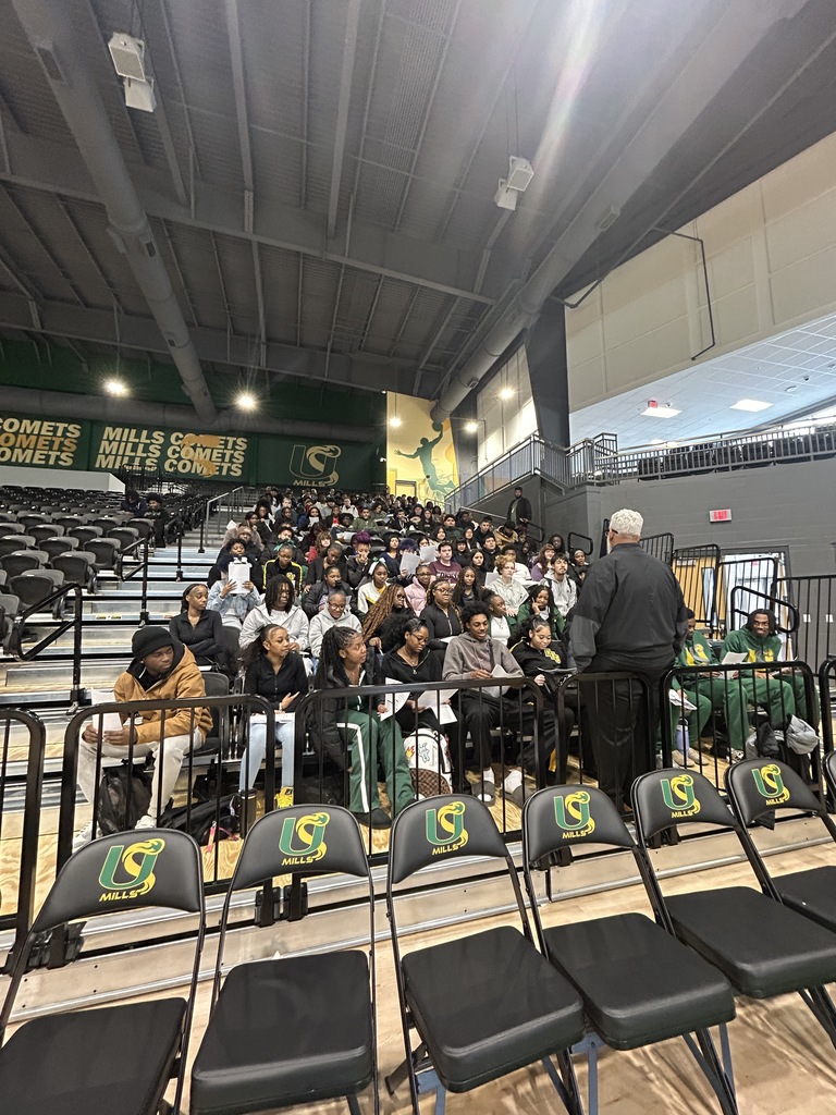 Principal speaking to the students in bleachers