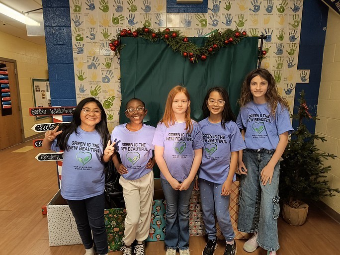 Baker Elementary students lined up shoulder to shoulder with shirts that say, "Green is the New Beautiful"