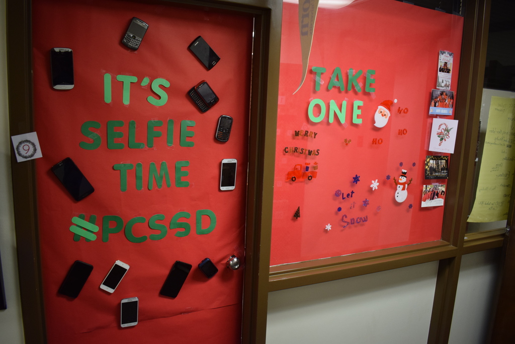 Holiday door decorated with many pictures saying "It's selfie time #PCSSD"
