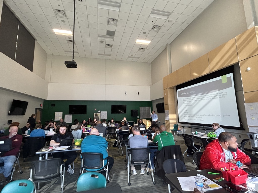 Full room of teachers receiving professional development. A presentation is projected saying, "Activity Labeling"