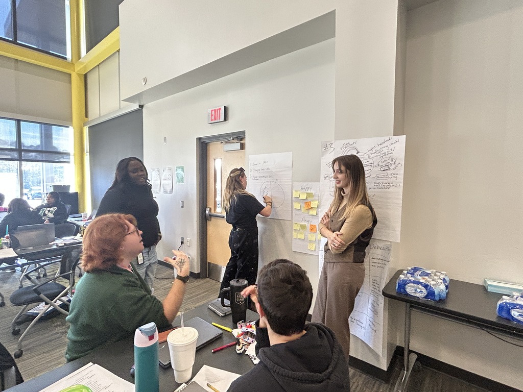 A group of teachers sitting and standing at a professional development session