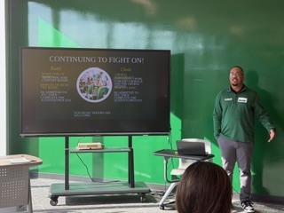 Guest speaker in front of TV presentation