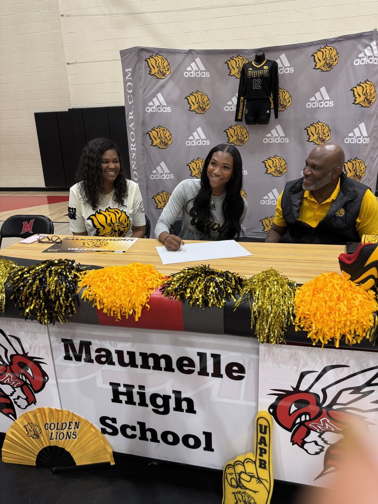 Three people sitting side by side. The woman in the middle is wearing a UAPB Volleyball shirt and about to sign a paper in front of her on a table that says Maumelle High School