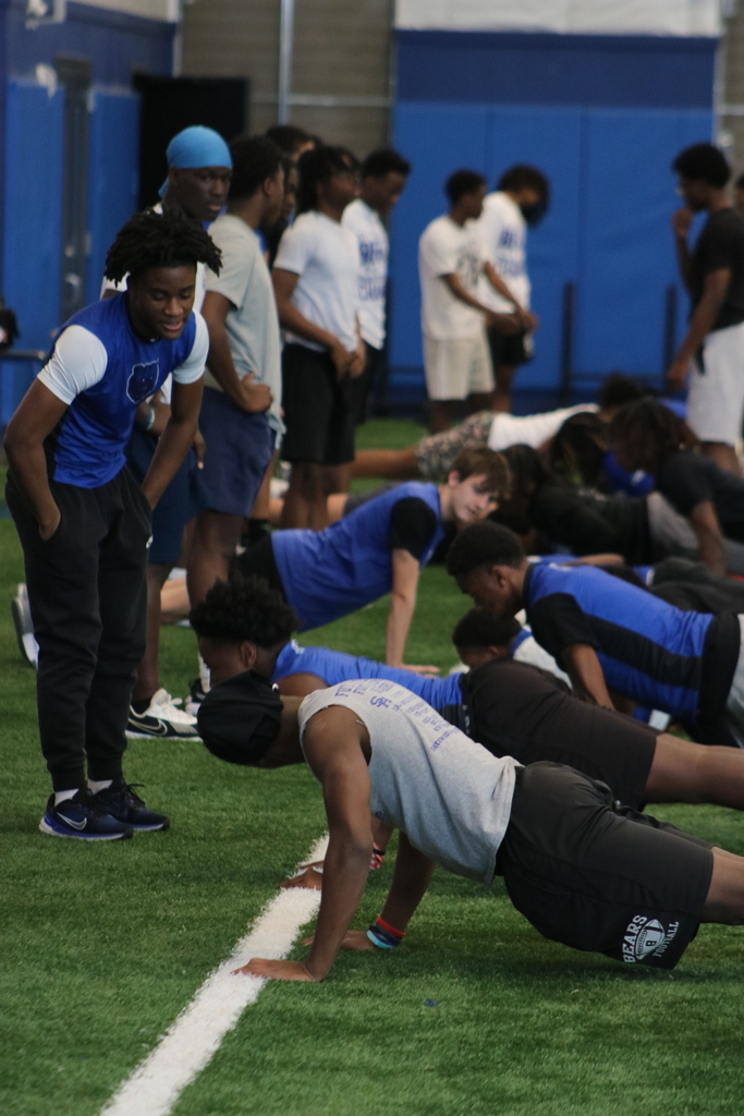 football players doing pushups