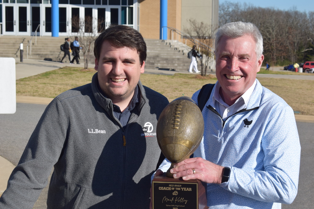 KATV's Jack Allen and Steve Sullivan holding a football trophy