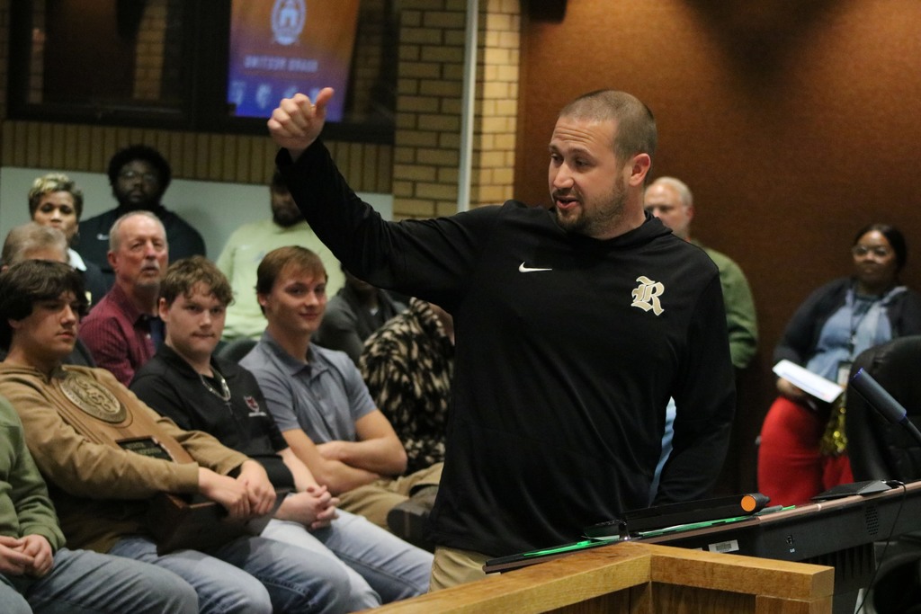 Coach Uptergrove looking back at his players during a speech
