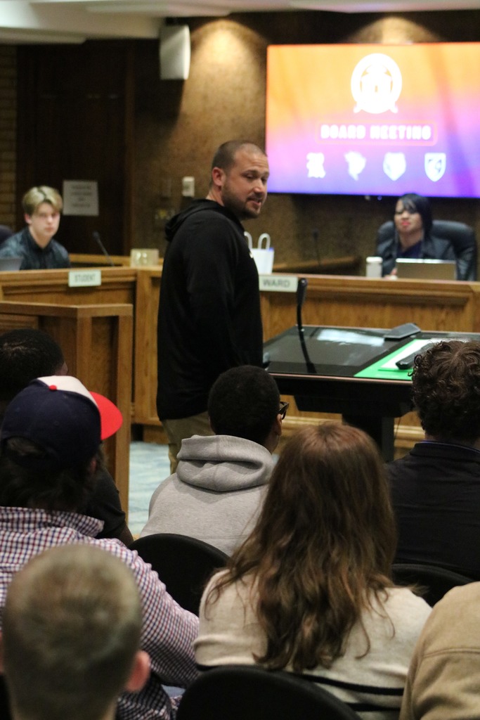 Coach Uptergrove looks back at his players in a board room