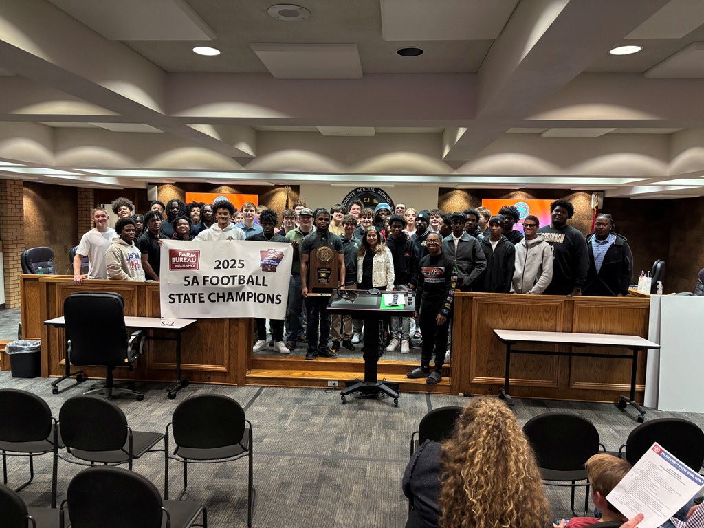 a team photo of the Joe T. Robinson State champs in a board room