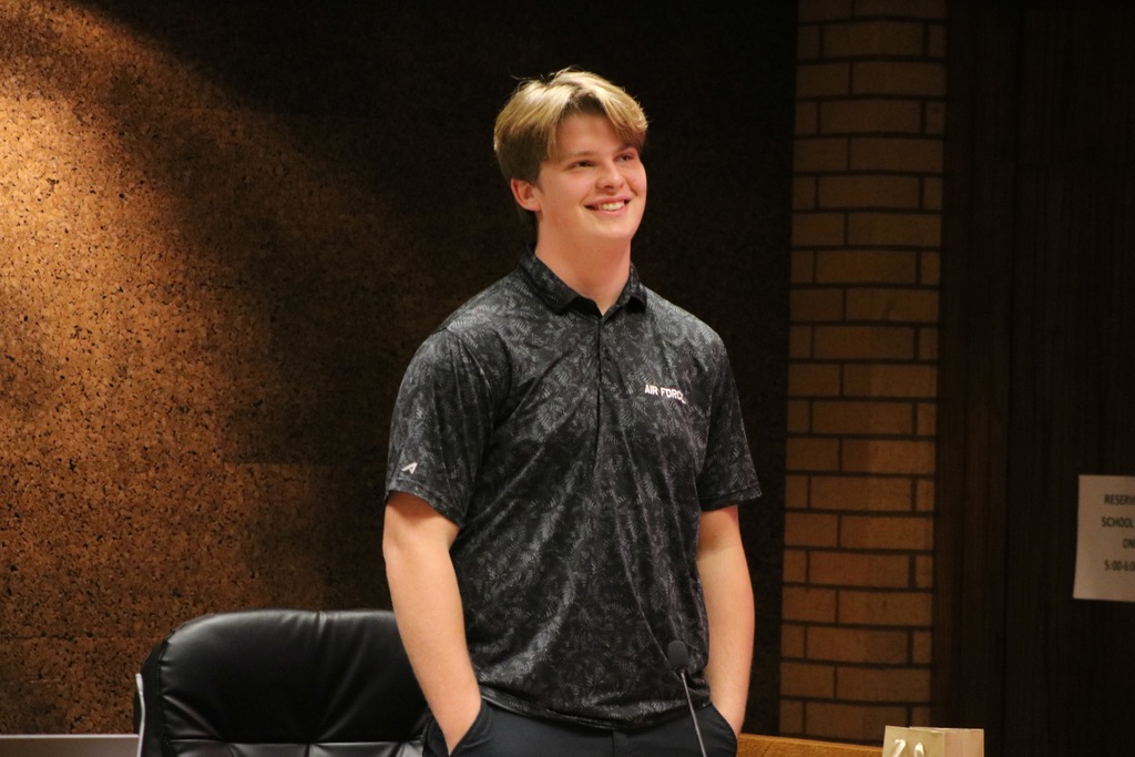 Student board member standing and smiling