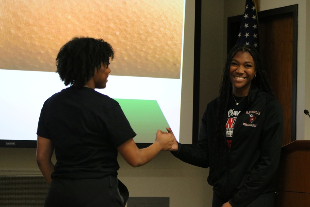 Students handshaking and smiling