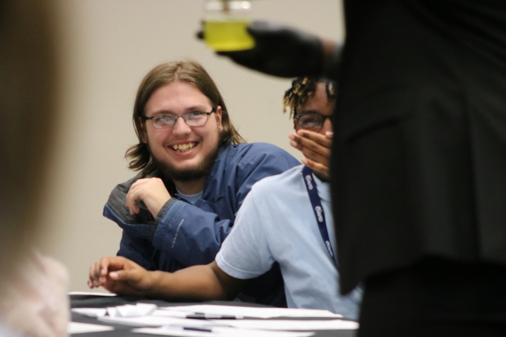 Two kids look scared at what is a rat draped over mountain dew