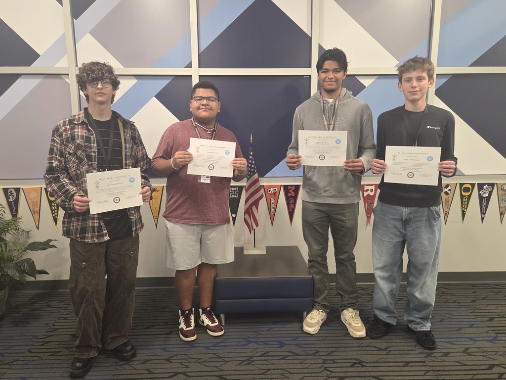 Four male Arkansas Seal of Biliteracy recipients standing side by side