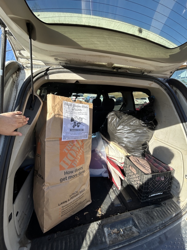 Sacks of winter wear items in a van