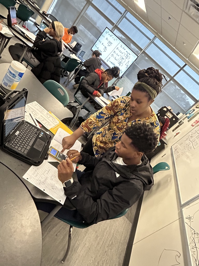 teacher helping student in math class