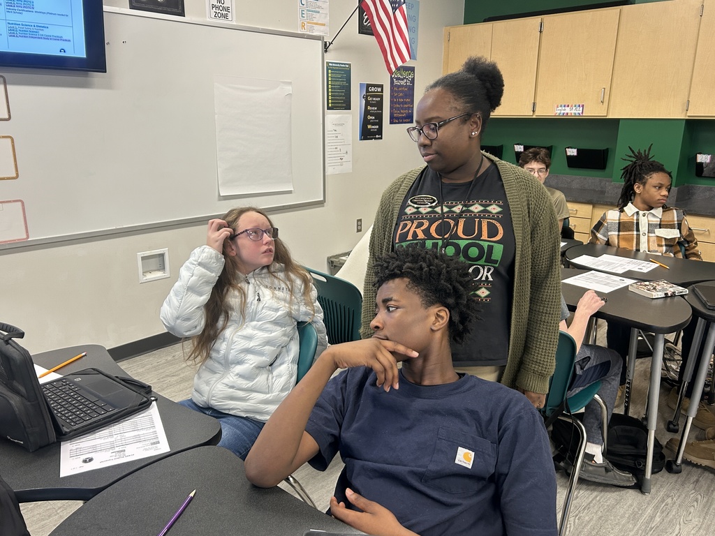 Counselor speaking to two students