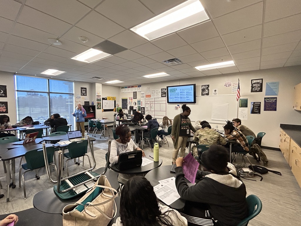 Counselors helping students in a classroom