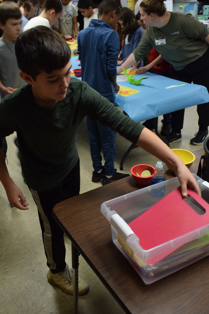 A student placing his cutting board in water