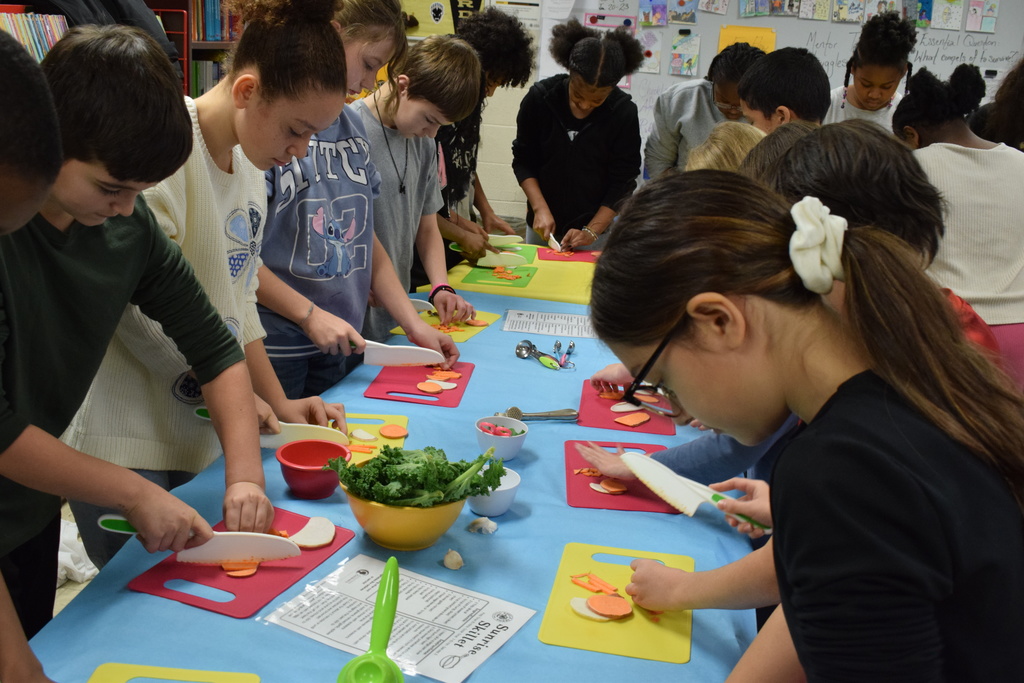 Students at a table with cutting vegetables