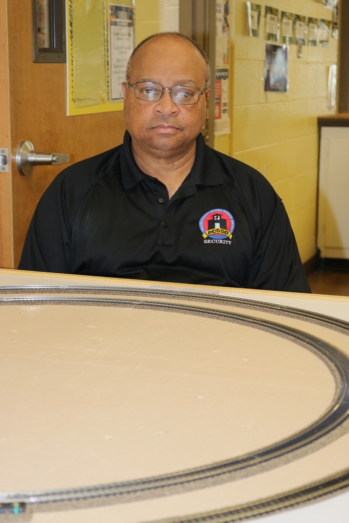Security Guard Jeff Bradford sits behind a table with train tracks