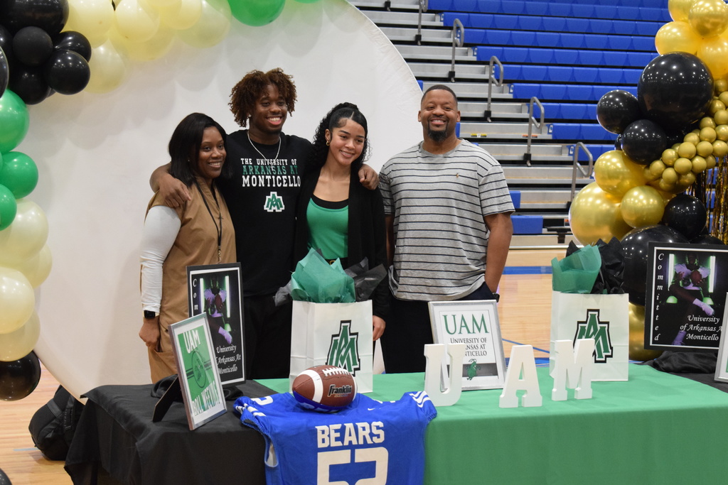 A student athlete smiles before signing his letter of intent for the University of Arkansas Monticello