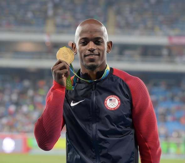 Olympian Jeff henderson holds his long jump gold medal