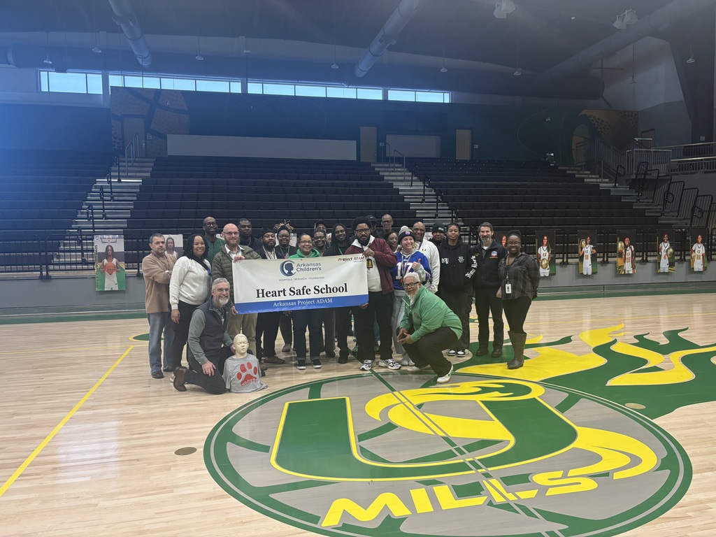 Group of educators and medical professionals around the Heart Safe School banner