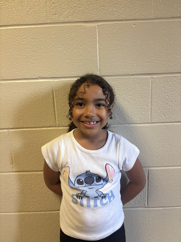 Second Grade student who was nominated for Student of the Month. She is in a white t shirt. 