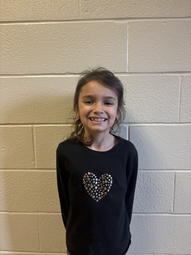 Second Grade student who was nominated for Student of the Month. She is in a black long sleeve t shirt. 