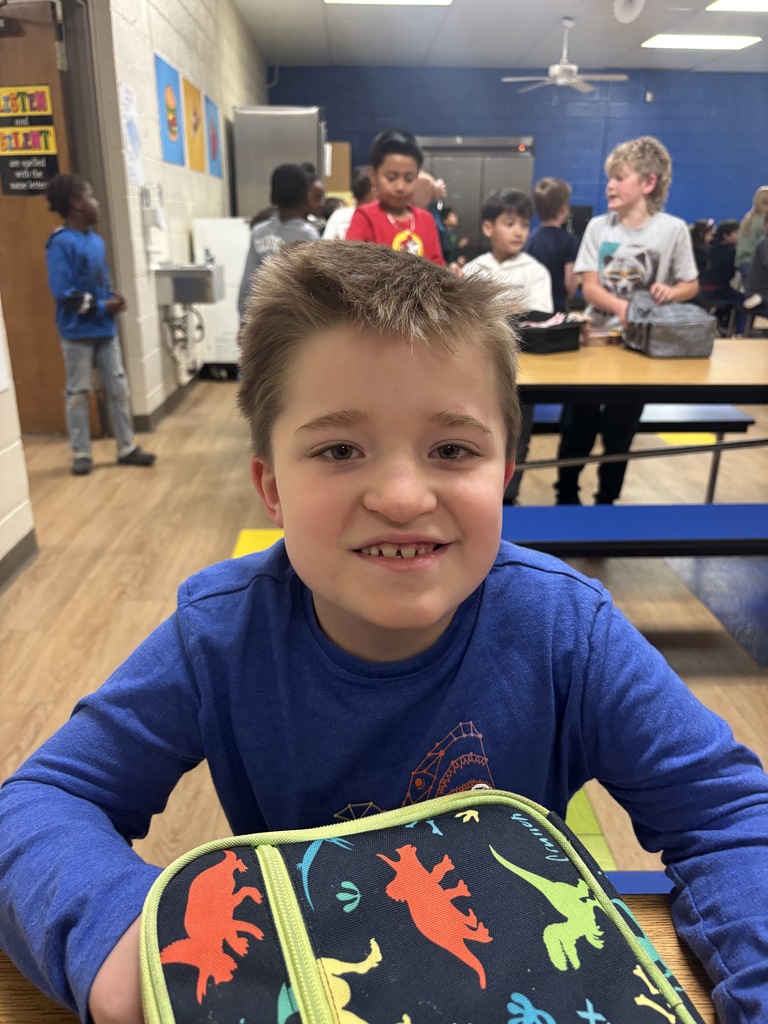 First Grade student who was nominated for Student of the Month.  He is in a blue shirt. 