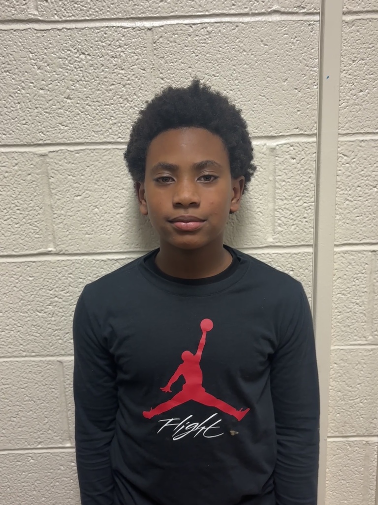 Image of fourth grade student who received student of the month. He is wearing a black long sleeve shirt. 