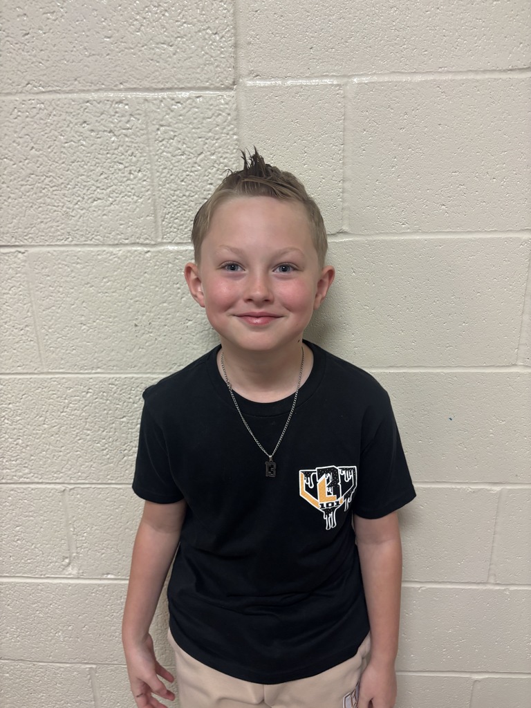 Third Grade student who was nominated for Student of the Month. He is in a black t shirt. 