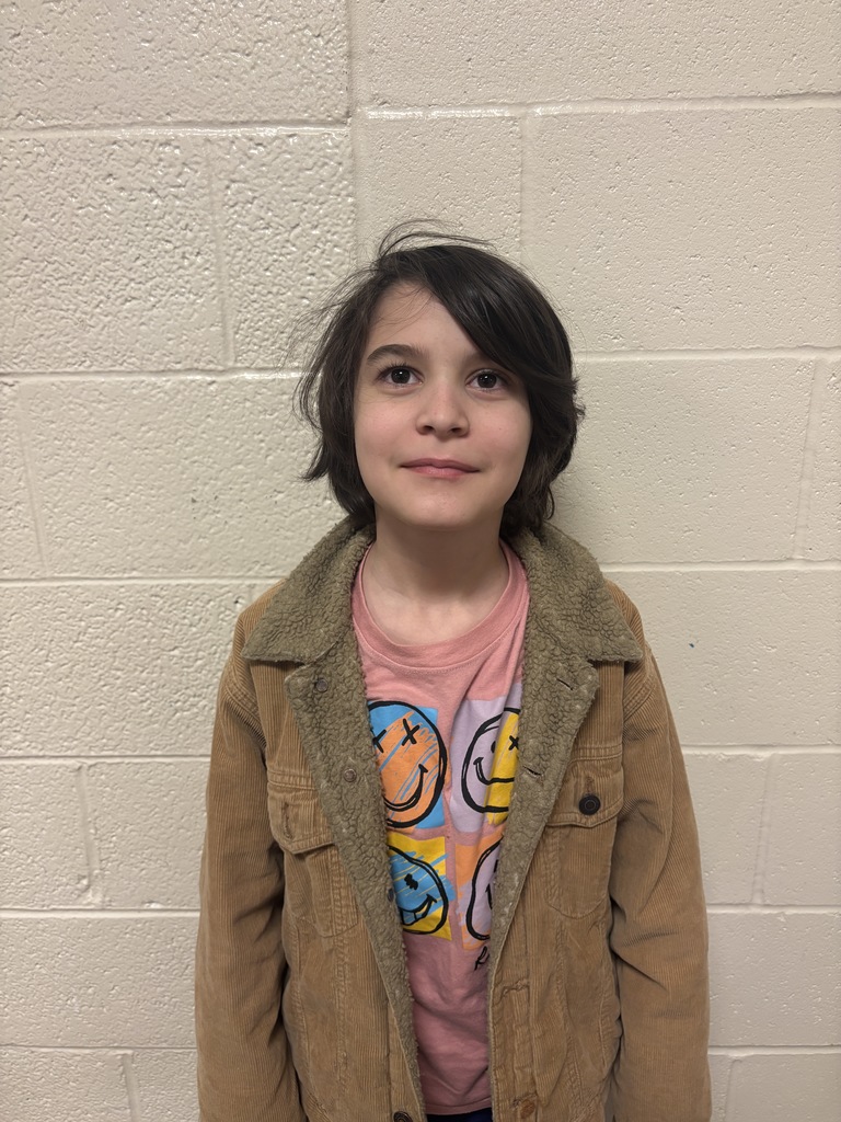 Third Grade student who was nominated for Student of the Month. He is in a peach t shirt and brown jacket. 