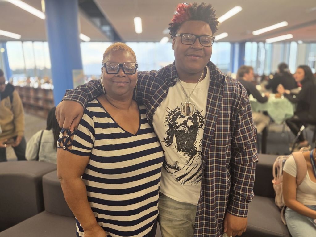 A picture of a mother and son smiling together