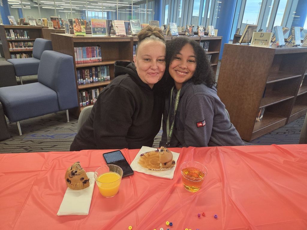 A picture of a mother and daughter smiling together