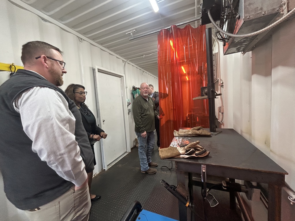 Adults looking at the welding spaces