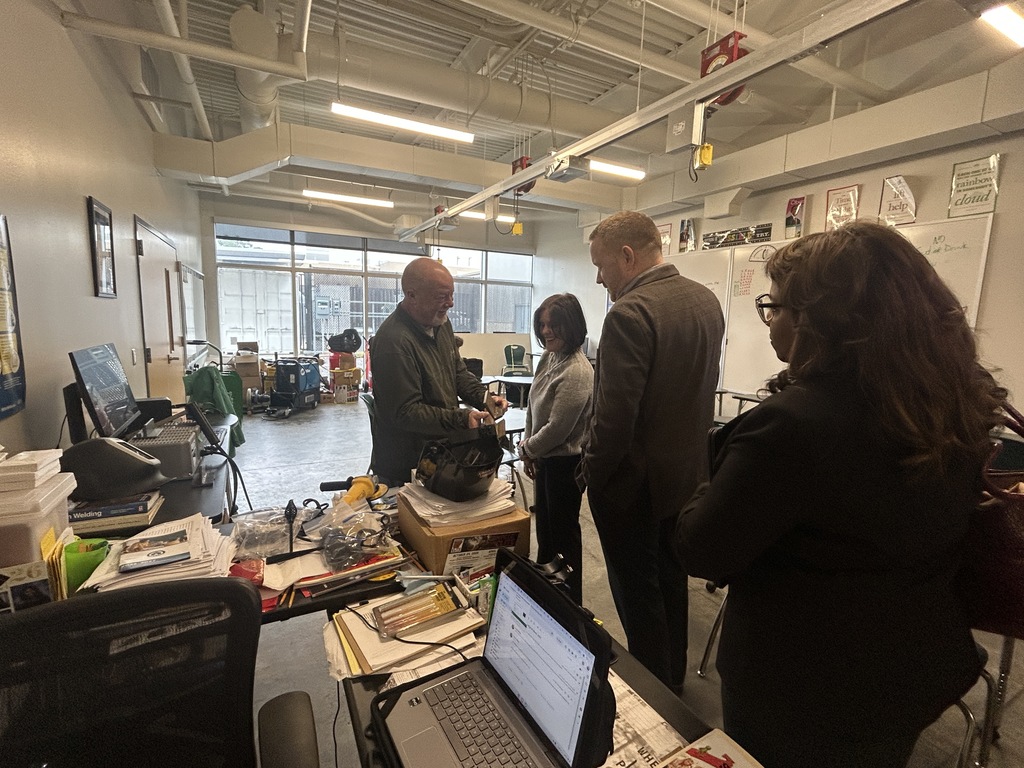 Adults looking at the welding classroom