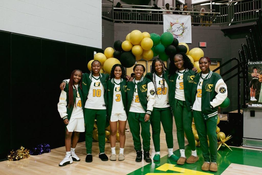 Seven senior from the Mills Lady Comets basketball team smile for the camera