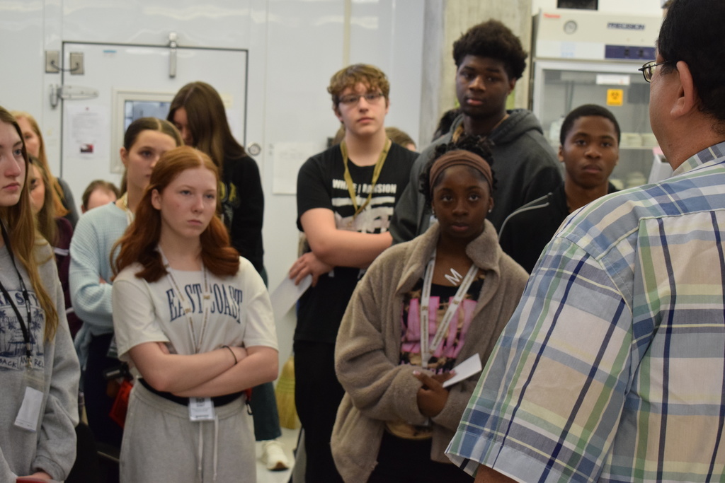 Joe T. Robinson High School Health Science Pathway tuberculosis. Many sudents are listening to a man in the foreground.